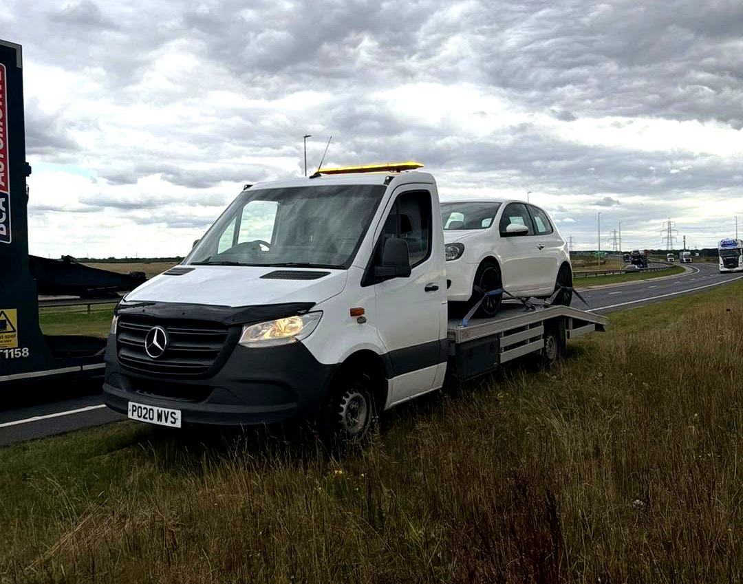HC Recoverys Mercedes recovery truck with a car loaded on the back, roadside near the Humber